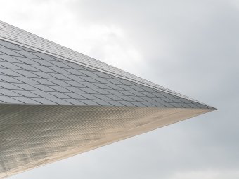 Graphic showing a fragment of the Swiss Tech Convention Center shaped like an arrowhead
